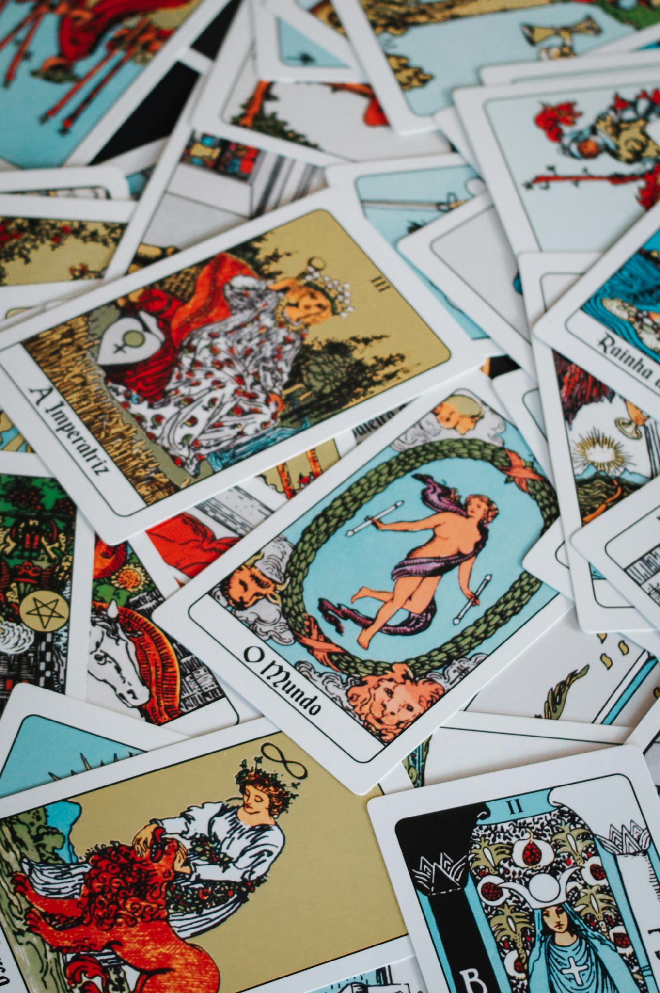 A colorful collection of tarot cards scattered artfully in a flat lay arrangement.