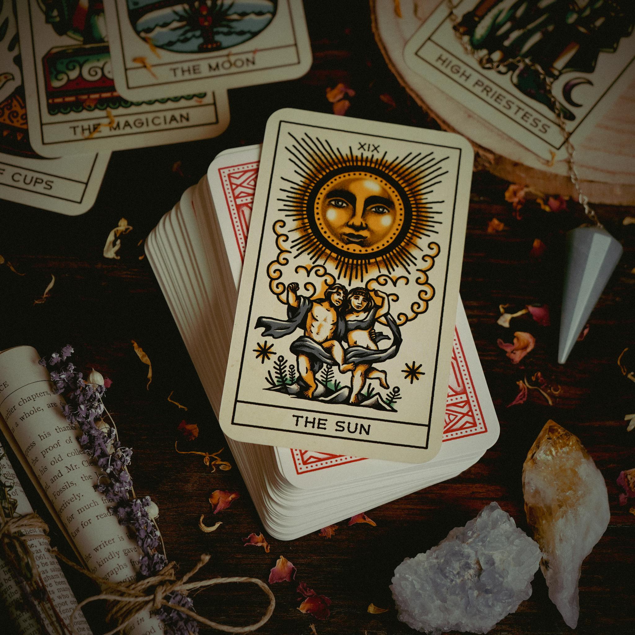 A spiritual setup featuring tarot cards, crystals, and divination tools.